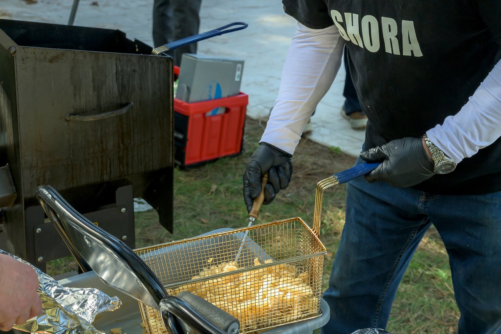 SHORA volunteer frying poutine at the Pumpkin Giveaway event