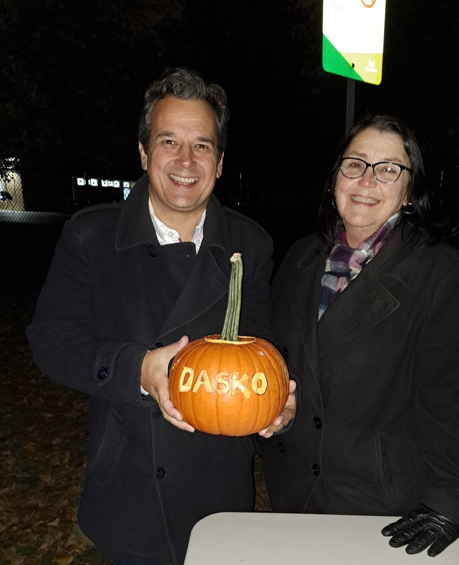 Councillor Stephen Dasko and a SHORA volunteer holding a pumpkin carved with 'DASKO' at the Pumpkin Walk